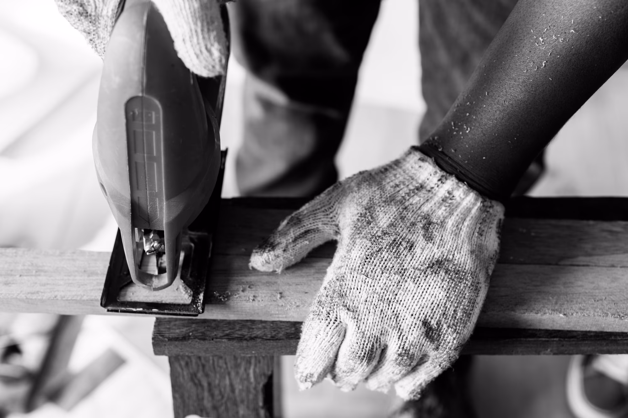 A carpenter using a circular saw to cut wood on a job site