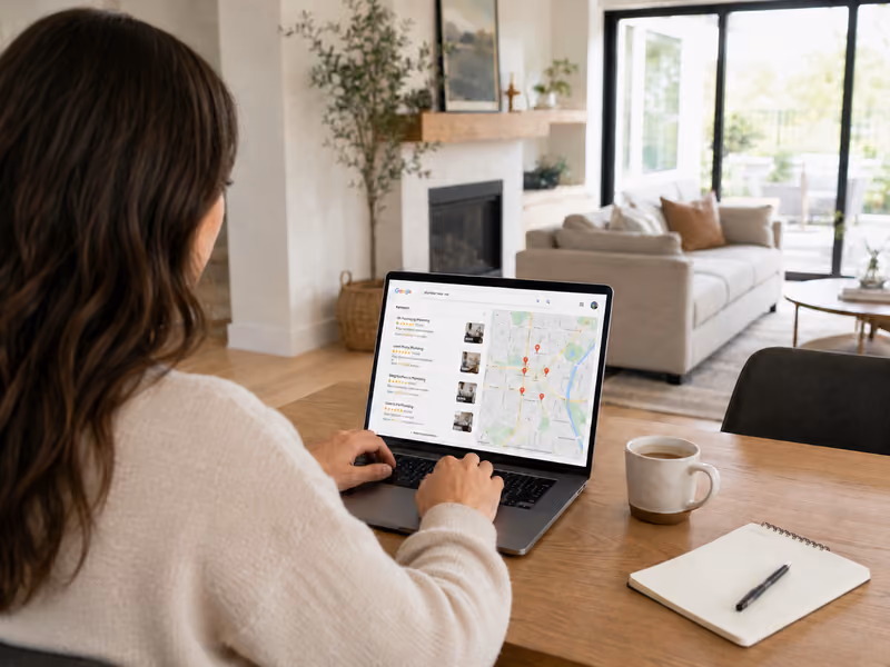 Local service professional meeting with client in office with laptop on desk