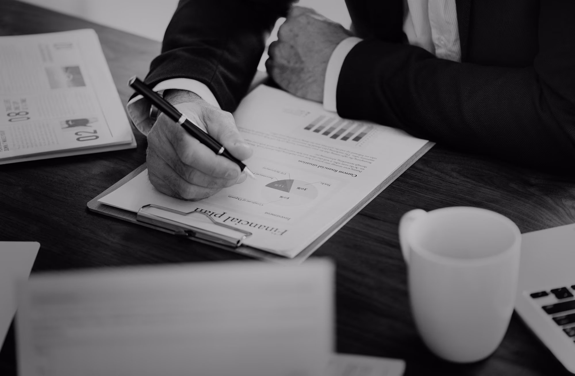 A professional services analyst reviewing business data at a desk
