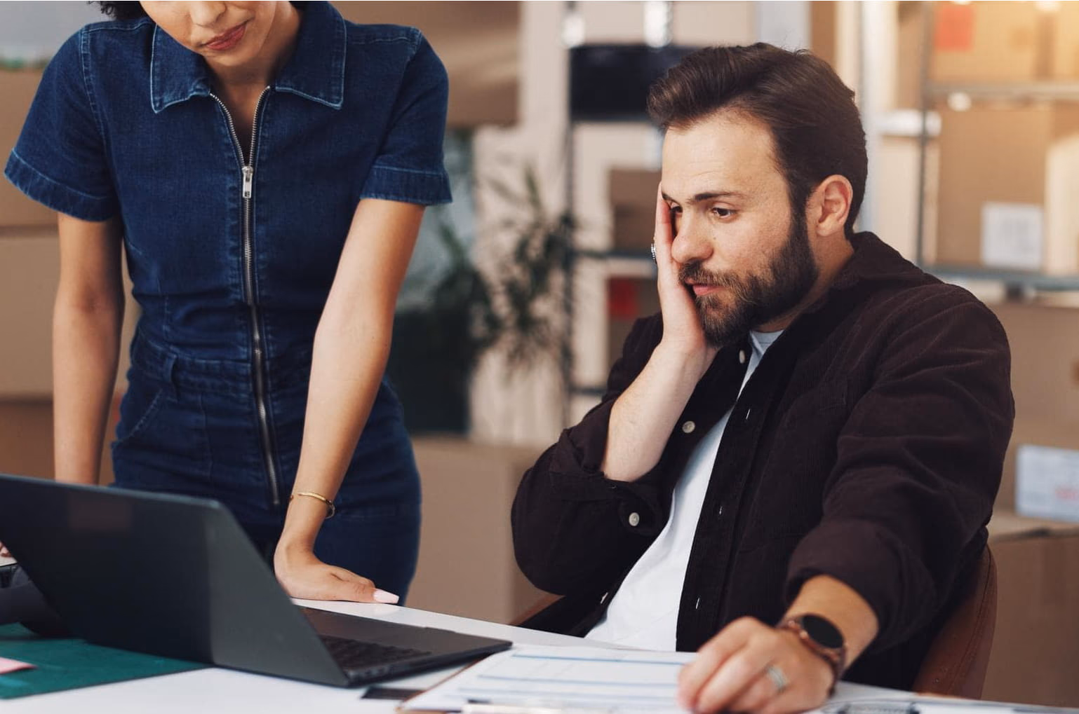 A frustrated business owner looking at a laptop, representing lost customers
